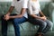 Unhappy married african american couple sitting on couch turn back