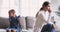 Unhappy mother and child daughter sit on sofa avoiding talk