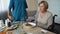 Unhappy old lady moving away piece of pie on the table, nursing service at home