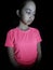 Unhappy Petite Filipina Juvenile Wearing Pink Isolated On Black