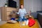 Unhappy redhaired ginger girl sorting waste:bottle,paper and plastic sitting at floor carpet in the living room in a