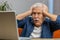 Unhappy sad senior elderly man use laptop bad news fortune loss, game fail lottery results at home