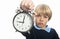 Unhappy schoolboy with clock