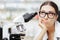 Unhappy Scientist Looking through a Microscope in a Laboratory