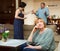Unhappy senior woman sitting, emotional woman quarrel with man