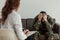 Unhappy soldier with depression and emotional problem during therapy with psychotherapist