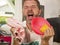 Unhappy and stressed man in kitchen apron feeling frustrated and upset overwhelmed by domestic chores washing dishes tired