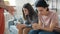 Unhappy teenagers brother and sister sitting on couch while parents yelling punishing kids at home