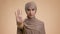Unhappy Victimized Muslim Woman Gesturing Stop Standing Over Beige Background