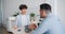 Unhappy wife fighting with husband during breakfast in kitchen talking gesturing