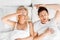 Unhappy woman in bed with snoring sleeping man