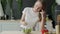 Unhappy woman eating vegetable salad at table in kitchen. Displeased young woman eating green leaf lettuce