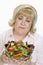 Unhappy Woman Holding Bowl Of Salad