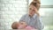 Unhappy woman holding sleeping baby on hands. Stress mother concept