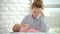 Unhappy woman holding sleeping baby on hands. Stress mother concept