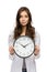 Unhappy woman keeping clock