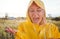 Unhappy Woman In Rain Wearing Waterproof Coat At Outdoor Music Festival