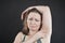 Unhappy woman shows her unshaved armpit. plus size middle age woman is not happy with hair in her armpits. Caucasian girl is
