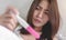 Unhappy young asian woman holding pregnancy test showing a positive result, Wellness and healthy concept, Abortion problem,