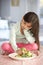 Unhappy Young Girl Rejecting Plate Of Fresh Vegetables