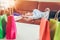 Unhappy young woman sleep on sofa and hold shopping bags with de