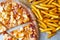 Unhealthy concept. Fast Food - Pizza, Fried Potato. Close up. Popular fast food recipes