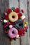 Unhealthy but delicious group of sweet sugar donut cakes and lots of gummy candies on vintage wooden table