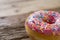 Unhealthy but delicious sweet sugar donut cake on vintage wooden table in lifestyle nutrition health care