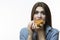 Unhealthy Eating Concepts. Caucasian Woman Eating Burger. Posing in Striped Shirt Indoors in Studio