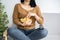 Unhealthy woman sitting on sofa  eating potato chips in bowl with remote tv on knee  watching something