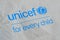 Unicef blue logo on brown paper bag, United Nations Childrens Fund is agency responsible for providing humanitarian and