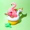 Unicorn, flamingo and pineapple swim tube on green background. Inflatable unicorn, flamingo and pineapple