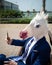 Unicorn makes a photo by phone. Young unusual man in funny mask