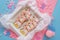 Unicorn shaped sugar cookies decorated with pastel royal icing on pink background