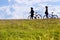 Unidentifiable bikers on the meadow, Czech republic - silhouette