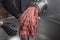 Unidentifiable butcher holding tray full of minced raw red meat leaving machine in food processing plant