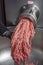 Unidentifiable butcher holding tray full of minced raw red meat leaving machine in food processing plant