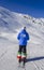 Unidentifiable female skiier from behind with a jacket written ITA which is short for Italy and pants with the italian flag at res