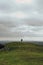 Unidentifiable man and a dog walking on top of a hill in Mendip Hills, UK
