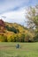 Unidentifiable Person Sits On Grass In Front Of A Colourful Backdrop