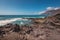 Unidentifiable Tourist swimming in coastline landscape in Puerto Santiago, Tenerife, Spain.