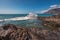 Unidentifiable Tourist swimming in coastline landscape in Puerto Santiago, Tenerife, Spain.