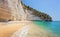 Unidentifiable tourists on a beautiful wild beach in Puglia, Italy, famous touristic destination in Europe. Tourists came with a