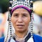 Unidentified Akha indigenous hill tribe woman in traditional clothes sells souvenirs , Thailand