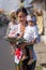 Unidentified balinese woman with a child carry offerings for gods during Galungan and Kuningan in Ubud, Bali