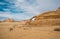 Unidentified bedouins with a caravan of camels walks in the desert of Wadi Rum
