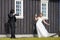 Unidentified bride and groom posing in front of Famous black church,Iceland.