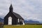 Unidentified bride and groom standing in front of Famous black church,Iceland.