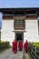 Unidentified buddhist monks with traditional robes are entering the Punakha Dzong monastery, Punakha, Bhutan