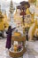 Unidentified burmese woman pouring water over the Buddha statue for blessing in Shwedagon pagoda in Yangon, Myanmar